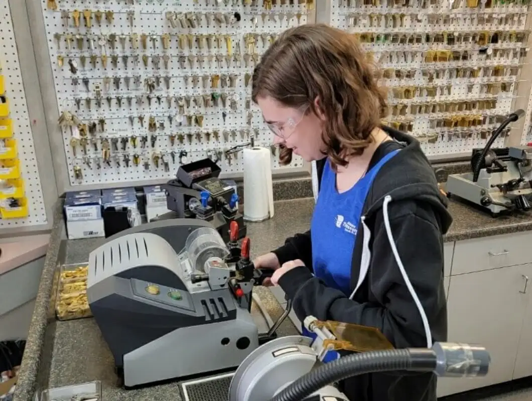 Technician at key-cutting machine